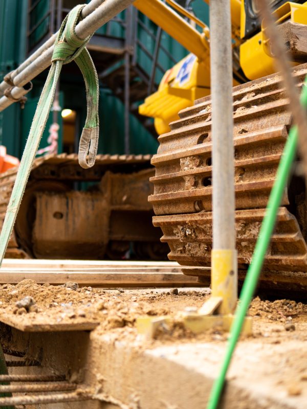 Detail of excavator tracks on construction site on the reinforced concrete floor